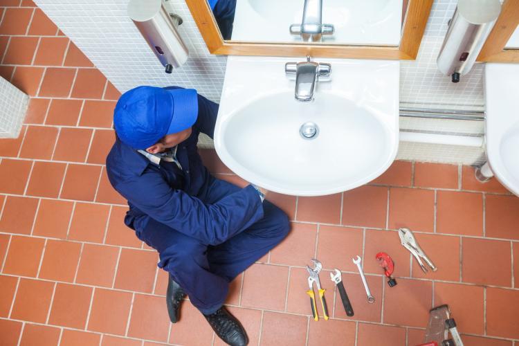 Plumber repairing Sink